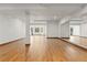 Large, unfurnished basement with wood-trimmed flooring, a bay window, and a mirrored wall at 1199 Links Ct, Erie, CO 80516