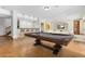 Finished basement with a pool table, bar seating, and a comfortable lounging area at 1199 Links Ct, Erie, CO 80516