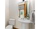 Powder bath featuring pedestal sink, framed mirror, and a modern design at 1199 Links Ct, Erie, CO 80516