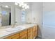 Well-lit bathroom with dual sinks and separate doorways for added convenience at 1199 Links Ct, Erie, CO 80516