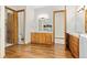 Large bathroom features dual vanities, a tub and a separate toilet area at 1199 Links Ct, Erie, CO 80516