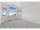 Empty room with a vaulted ceiling and a large bright window at 1199 Links Ct, Erie, CO 80516