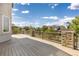 An outdoor deck area features lovely stone supports and a metal railing system overlooking the backyard at 1199 Links Ct, Erie, CO 80516