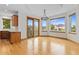 Sunlit dining area features hardwood floors, stylish lighting, and a balcony entrance at 1199 Links Ct, Erie, CO 80516