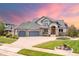 Beautiful home features a three-car garage, manicured lawn, and inviting front entrance at 1199 Links Ct, Erie, CO 80516