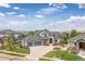 Beautiful two-story home with stone accents, a three-car garage, and a well-manicured lawn at 1199 Links Ct, Erie, CO 80516