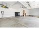 Spacious three car garage with high ceilings, storage cabinets, and an electric car charging port at 1199 Links Ct, Erie, CO 80516