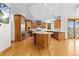 Bright eat-in kitchen featuring wood cabinets, stainless steel appliances and an island with bar seating at 1199 Links Ct, Erie, CO 80516