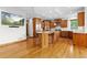 Kitchen features hardwood floors, island with seating, and stainless steel appliances at 1199 Links Ct, Erie, CO 80516