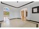 Open concept living room with tile flooring, multiple entrances, and dark trim at 1199 Links Ct, Erie, CO 80516