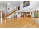 Open-concept living space with staircase connecting to the kitchen at 1199 Links Ct, Erie, CO 80516
