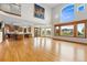Open-concept living space with hardwood floors connecting to a gourmet kitchen at 1199 Links Ct, Erie, CO 80516