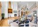 Bright living room boasts high ceilings, fireplace, hardwood floors, and staircase at 1199 Links Ct, Erie, CO 80516