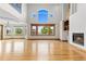 Spacious living room filled with natural light, hardwood floors, and a fireplace at 1199 Links Ct, Erie, CO 80516