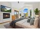Bright main bedroom features a fireplace, deck access, and large windows with neighborhood views at 1199 Links Ct, Erie, CO 80516