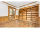 Office with wood floors, wood trim, built-in bookcases and glass paned french doors at 1199 Links Ct, Erie, CO 80516