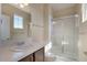 Bathroom featuring a shower with sliding glass doors and a sink with dark wood cabinets at 7887 Vallagio Ln, Englewood, CO 80112