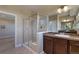 Bathroom featuring a glass-enclosed shower and dual vanity at 7887 Vallagio Ln, Englewood, CO 80112