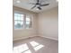 A bright, carpeted bedroom with natural light from two large windows at 7887 Vallagio Ln, Englewood, CO 80112