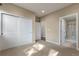 A bright, neutral bedroom features large closet doors and an en-suite bathroom with glass shower at 7887 Vallagio Ln, Englewood, CO 80112