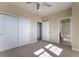 Bright bedroom boasts carpet, closet, and direct access to an ensuite bathroom at 7887 Vallagio Ln, Englewood, CO 80112