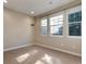 Neutral bedroom features carpet, natural light from two windows, and a minimalist aesthetic at 7887 Vallagio Ln, Englewood, CO 80112