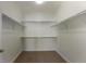 This is a walk-in closet that has shelving on the walls and a carpeted floor at 7887 Vallagio Ln, Englewood, CO 80112