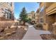 Charming courtyard with a peaceful walkway and well-maintained landscaping, creating a serene outdoor space at 7887 Vallagio Ln, Englewood, CO 80112