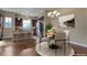 Eat-in kitchen with modern appliances, island seating, and a cozy dining area at 7887 Vallagio Ln, Englewood, CO 80112