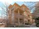 Stunning exterior view of a multi-story residence with stone and stucco accents at 7887 Vallagio Ln, Englewood, CO 80112