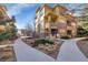 Beautiful townhouse with stone accents, balconies, manicured landscaping, and winding walkways at 7887 Vallagio Ln, Englewood, CO 80112