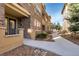 The exterior showcases stone accents, a pathway to the home, and well-maintained landscaping at 7887 Vallagio Ln, Englewood, CO 80112