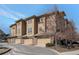 This is a building with stone and beige siding at 7887 Vallagio Ln, Englewood, CO 80112