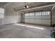 This is a garage with concrete floor and a white garage door at 7887 Vallagio Ln, Englewood, CO 80112