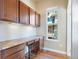 Cozy built-in office space with wooden cabinets, drawers, and a bright window at 7887 Vallagio Ln, Englewood, CO 80112