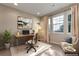 Bright office space with a large window, modern desk, and comfortable seating area at 7887 Vallagio Ln, Englewood, CO 80112