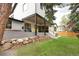 Expansive backyard featuring a covered patio and a stone wall, perfect for outdoor entertaining and relaxing at 62 Jasmine St, Denver, CO 80220