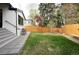 A grassy backyard and tall mature trees creates a serene and picturesque outdoor setting at 62 Jasmine St, Denver, CO 80220