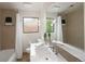 Bright bathroom featuring a shower-tub combo, modern fixtures, and unique decorative lighting at 62 Jasmine St, Denver, CO 80220