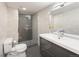 Modern bathroom featuring sleek gray tiles, a glass shower, and stylish vanity at 62 Jasmine St, Denver, CO 80220