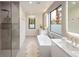 Modern bathroom with a sleek shower, a soaking tub, and large windows at 62 Jasmine St, Denver, CO 80220