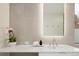 Modern bathroom with a lighted mirror, white countertop, sleek fixtures, and natural accents create a spa-like ambiance at 62 Jasmine St, Denver, CO 80220