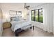 Bright bedroom with a ceiling fan, hardwood floors, a large window, and ample natural light at 62 Jasmine St, Denver, CO 80220