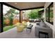 Comfortable covered patio with lush green trees and a hot tub, perfect for relaxing and entertaining at 62 Jasmine St, Denver, CO 80220