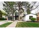 Modern home featuring a stone facade, black trim, and a well-manicured front lawn at 62 Jasmine St, Denver, CO 80220