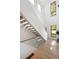 Bright entry way with staircase, glass railing, and lots of natural light at 62 Jasmine St, Denver, CO 80220