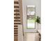 Bright foyer featuring a modern staircase, large window, and hardwood floors at 62 Jasmine St, Denver, CO 80220