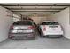 A spacious garage with two cars parked, offering ample space for vehicles and storage at 62 Jasmine St, Denver, CO 80220