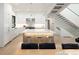Modern kitchen with white cabinets, stainless steel appliances, and large center island at 62 Jasmine St, Denver, CO 80220