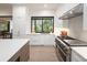 Contemporary kitchen featuring stainless steel appliances and white cabinetry at 62 Jasmine St, Denver, CO 80220